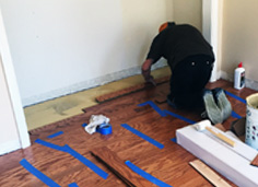 Image of Green Diamond Flooring EMployee working on Floor. 