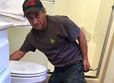 Close up image of Green Diamond Flooring EMployee working on Floor. 